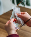 Person using Premoistened Lens Cleaning Wipes For Glasses Phones And Cameras Pack Of 1000 to clean eyeglasses.
