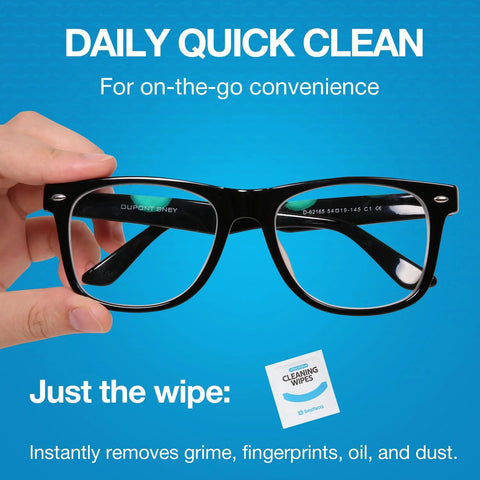 Hand holding eyeglasses with a cleaning wipe package, demonstrating the Lens Wipes And Microfiber Cloths Value Kit For Eyeglasses And Screens.