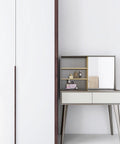 White cabinet with hidden handle and modern vanity table with mirror in room setting.