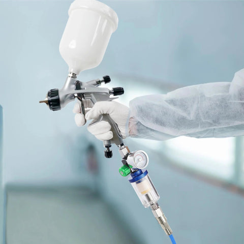 Oil Water Separator With Integrated Air Filter And Pressure Regulator For Spray Guns And Air Tools Inlet And Outlet G1 Quarter Inch Clear Water Filter Stainless Steel Adapter Compact Inline Unit For Compressors That Keeps Lines Clean And Extends Tool Life attached to a spray gun in use.