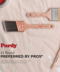 Purdy paintbrushes on textured surface, showcasing brand preference award, with red accents and bristles visible.