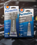 Permatex 81150 Dielectric Tune-Up Grease, 0.33 oz. Tube, Silver packaging front view with automotive background