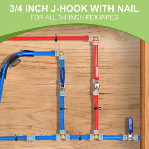 Plumbing installation with red and blue 3/4 inch PEX pipes using J-hooks and nails on wooden board.