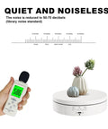 White Rotating Display Stand With USB And Battery Power shown with noise level meter reading 58.6 decibels and small vases.