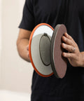 Person holding Radius360 Round Sanding Tool with Interchangeable Center Hub 9 Inch, showing front and back sides.