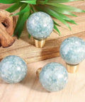 Pack of 2 Round Resin Aquamarine Drawer Knobs With Screws, Ball Shape Crystal Pulls for kitchen decor on wooden surface