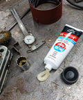 SIL-Glyde Multi-Purpose All-Weather Lubricating Compound for All Surfaces - 8 oz Tube on workshop table.