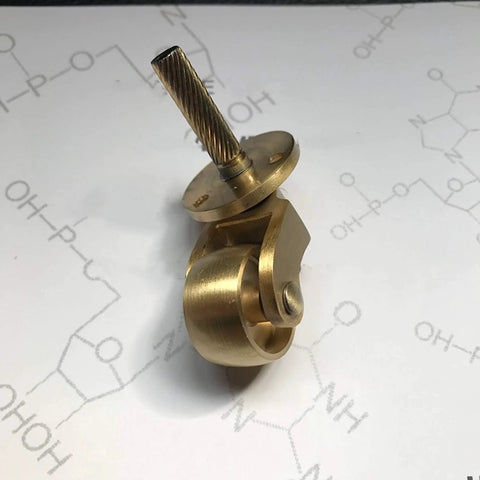 Side view of a Solid Brass Caster Set With 25mm Wheels, 360 Degree Swivel, Screw Mount Fittings, ideal for furniture use.
