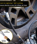 Side view of a Lightning L2X Quick Connect Locking Tire Inflator Air Chuck Extension with 90° adapter attached to a tire.