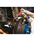 Applying WD-40 Specialist Penetrant with Smart Straw on metal and rubber vehicle components.