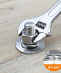Wrench tightening bolt with Spring Lock Washer Set SAE Four To Three Quarter Inch 304 Stainless Steel on wooden surface.